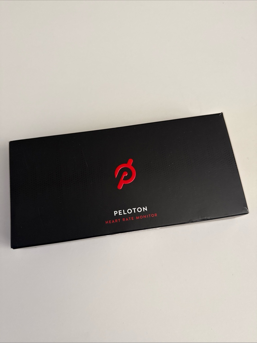 PELOTON NIB HEART RATE MONITOR, Factory plastic seal still on face